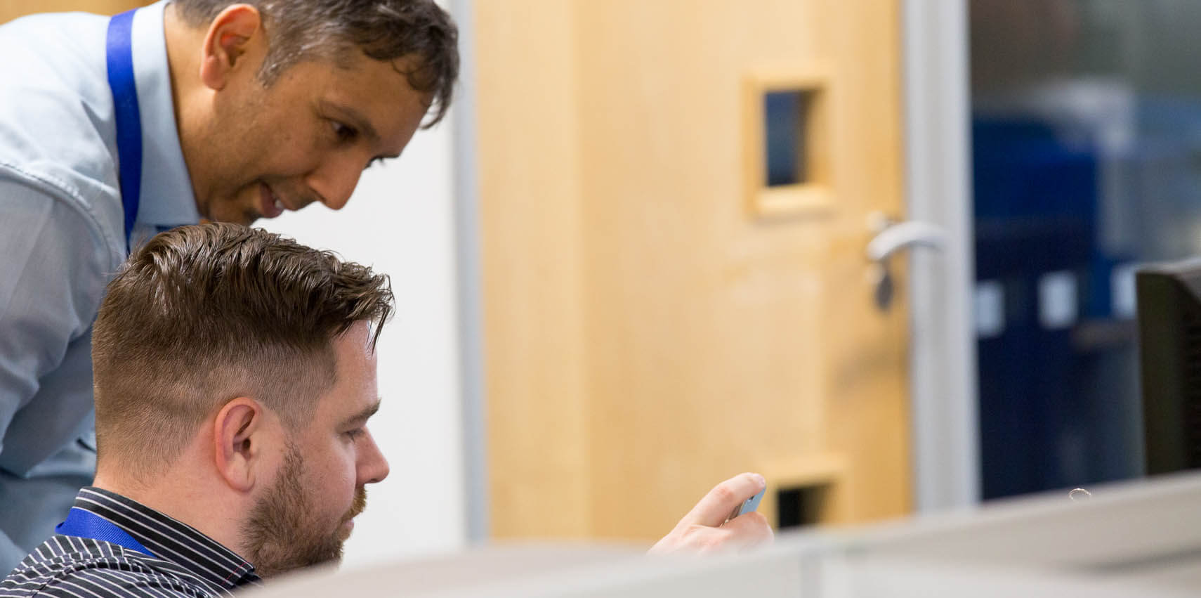 employees-looking-at-device